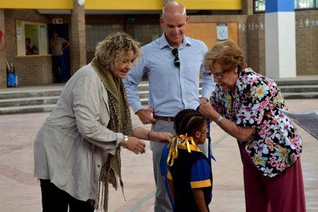 MP Michael Cardo and Mayor Nicolette Botha-Guthrie, along with Ward 4 Councillor Lianda Beyers-Cronjé assist a grade-one learner with her backpack at the specially marked ceremony at Mount Pleasant Primary,   where  three  classes  of  grade-one  learners  received  a   stationery-filled backpack courtesy of the Ward 4 Backpack Project.